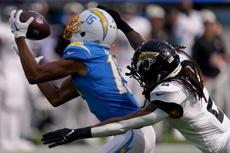 Los Angeles Chargers wide receiver Jalen Guyton (15) catches a pass against Jacksonville Jaguars safety Rayshawn Jenkins during the second half of an NFL football game in Inglewood, Calif., Sunday, Sept. 25, 2022. (AP Photo/Mark J. Terrill)