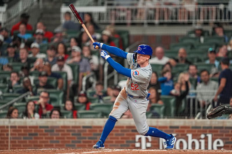 May 15, 2024; Cumberland, Georgia, USA; Chicago Cubs center fielder Pete Crow-Armstrong (52) hits a triple against the Atlanta Braves during the eight inning at Truist Park. Mandatory Credit: Dale Zanine-USA TODAY Sports