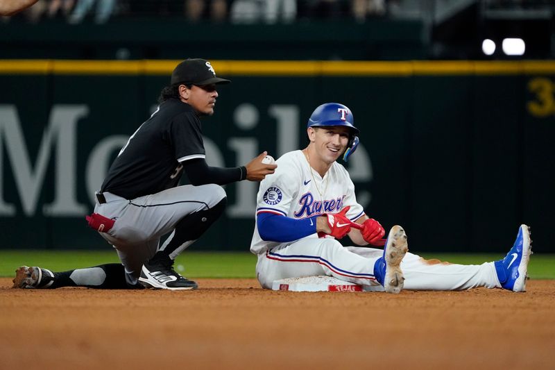 Jul 22, 2024; Arlington, Texas, USA; Texas Rangers left fielder Wyatt Langford (36) sits on second base after hitting a double during the ninth inning as Chicago White Sox second baseman Nicky Lopez (8) looks on at Globe Life Field. Mandatory Credit: Raymond Carlin III-USA TODAY Sports