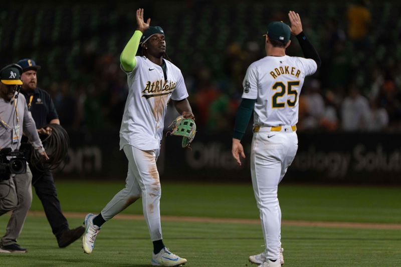 Jul 23, 2024; Oakland, California, USA;  Oakland Athletics outfielder Lawrence Butler (4) and outfielder Brent Rooker (25) celebrate after defeating the Houston Astros at Oakland-Alameda County Coliseum. Mandatory Credit: Stan Szeto-USA TODAY Sports