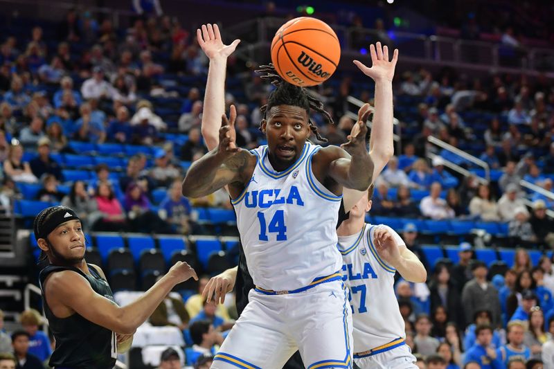 January 14, 2024; Los Angeles, California, USA; UCLA Bruins forward Kenneth Nwuba (14) plays for the rebound against Washington Huskies guard Koren Johnson (0) during the first half at Pauley Pavilion. Mandatory Credit: Gary A. Vasquez-USA TODAY Sports