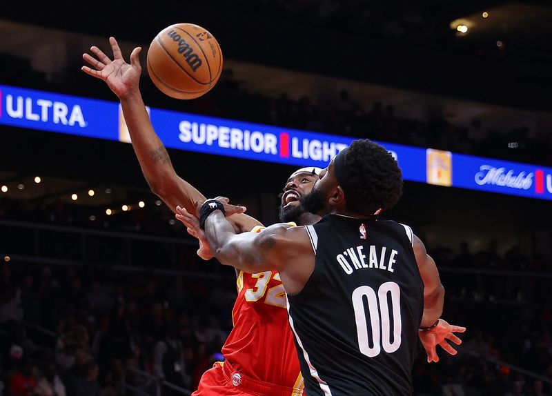 ATLANTA, GEORGIA - DECEMBER 06:  Wesley Matthews #32 of the Atlanta Hawks draws a foul as he drives against Royce O'Neale #00 of the Brooklyn Nets during the second quarter at State Farm Arena on December 06, 2023 in Atlanta, Georgia.  NOTE TO USER: User expressly acknowledges and agrees that, by downloading and/or using this photograph, user is consenting to the terms and conditions of the Getty Images License Agreement.  (Photo by Kevin C. Cox/Getty Images)