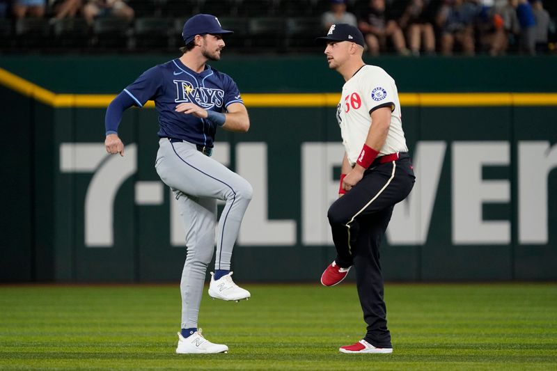 Jul 5, 2024; Arlington, Texas, USA; Tampa Bay Rays outfielder Josh Lowe (15) and Texas Rangers first baseman Nathaniel Lowe (30), who are brothers talk prior to a game at Globe Life Field. Mandatory Credit: Raymond Carlin III-USA TODAY Sports