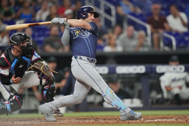 Jun 4, 2024; Miami, Florida, USA; Tampa Bay Rays second baseman Brandon Lowe (8) hits a double in the fifth inning against the Miami Marlins at loanDepot Park. Mandatory Credit: Jim Rassol-USA TODAY Sports