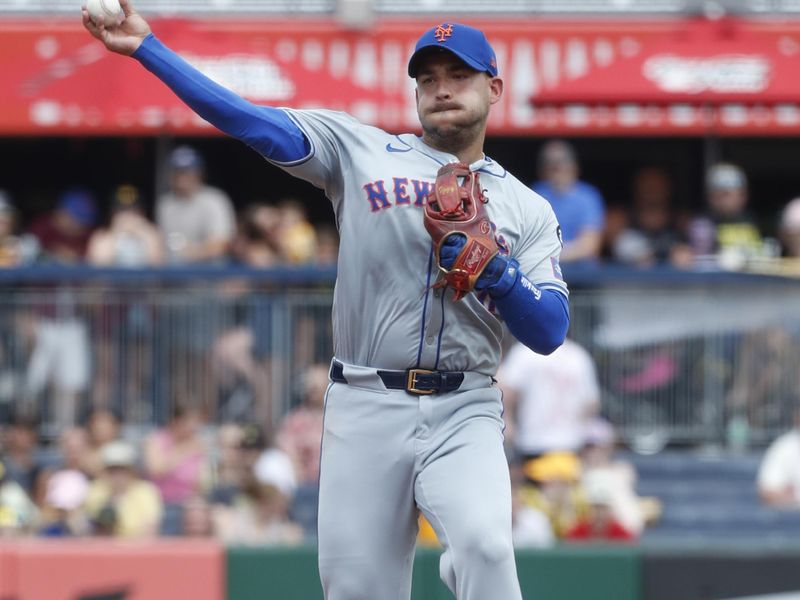 Jul 7, 2024; Pittsburgh, Pennsylvania, USA;  New York Mets second baseman Jose Iglesias (11) throws to first base for an out against Pittsburgh Pirates shortstop Jared Triolo (19) during the fifth inning at PNC Park. The Mets won 3-2. Mandatory Credit: Charles LeClaire-USA TODAY Sports