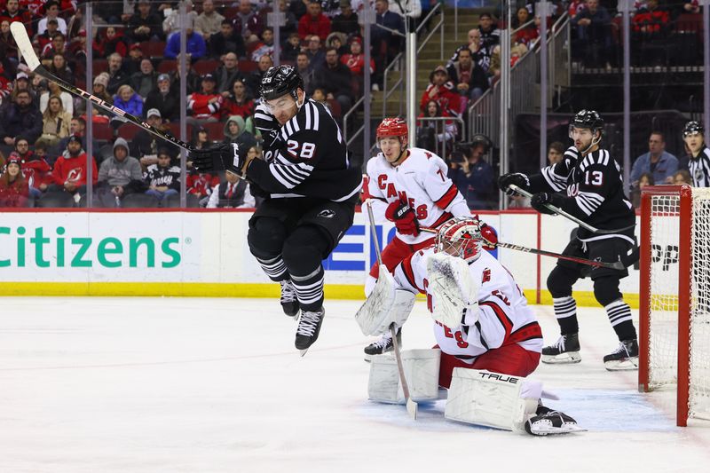 Mar 9, 2024; Newark, New Jersey, USA; New Jersey Devils right wing Timo Meier (28) attempts to screen Carolina Hurricanes goaltender Pyotr Kochetkov (52) during the second period at Prudential Center. Mandatory Credit: Ed Mulholland-USA TODAY Sports