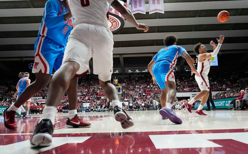 Jan 14, 2025; Tuscaloosa, AL, USA;  Alabama guard Labaron Philon (0) lobs an inbound pass to Alabama guard Mark Sears (1) during the game with Ole Miss at Coleman Coliseum. Mandatory Credit: Gary Cosby Jr.-USA TODAY Network via Imagn Images