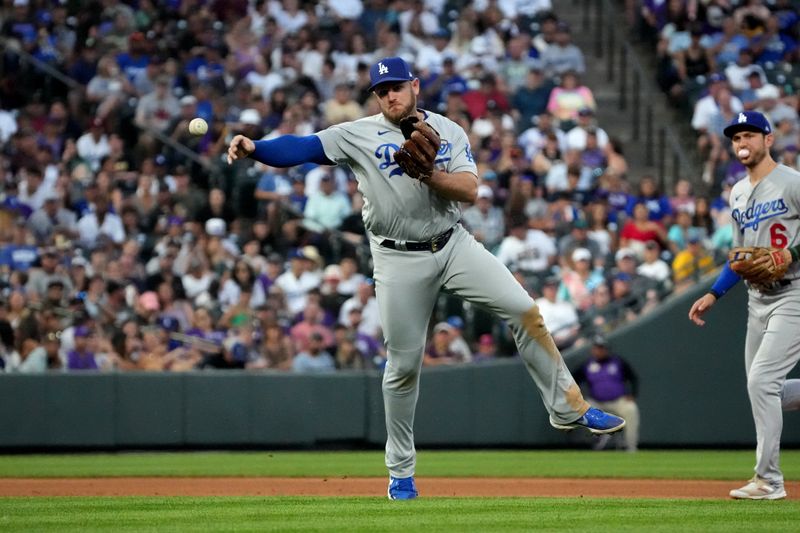 Jul 30, 2022; Denver, Colorado, USA; Los Angeles Dodgers third baseman Max Muncy (13) fields the ball against the Colorado Rockies in the seventh inning at Coors Field. Mandatory Credit: Ron Chenoy-USA TODAY Sports