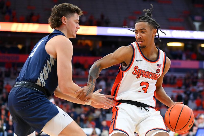 Nov 6, 2023; Syracuse, New York, USA; Syracuse Orange guard Judah Mintz (3) controls the ball as New Hampshire Wildcats forward Jaxson Baker (3) defends during the second half at the JMA Wireless Dome. Mandatory Credit: Rich Barnes-USA TODAY Sports