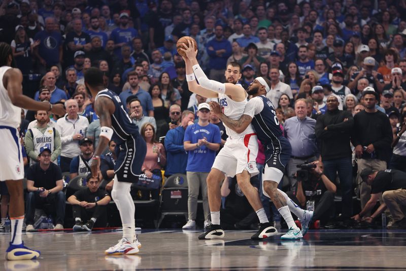 DALLAS, TX - APRIL 28: Ivica Zubac #40 of the LA Clippers handles the ball during the game against the Dallas Mavericks during Round 1 Game 4 of the 2024 NBA Playoffs on April 28, 2024 at the American Airlines Center in Dallas, Texas. NOTE TO USER: User expressly acknowledges and agrees that, by downloading and or using this photograph, User is consenting to the terms and conditions of the Getty Images License Agreement. Mandatory Copyright Notice: Copyright 2024 NBAE (Photo by Tim Heitman/NBAE via Getty Images)