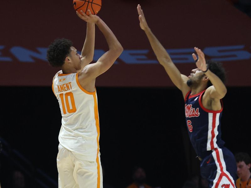 Feb 3, 2026; Knoxville, Tennessee, USA;  Tennessee Volunteers forward Nate Ament (10) shoots a three pointer against Mississippi Rebels guard Ilias Kamardine (6) during the second half at Thompson-Boling Arena at Food City Center. Mandatory Credit: Randy Sartin-Imagn Images
