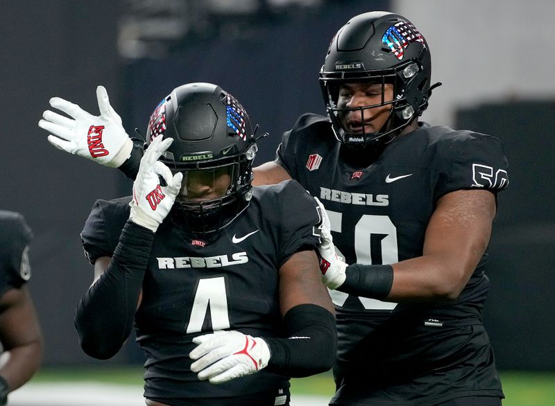 Nov 19, 2021; Paradise, Nevada, USA; UNLV Rebels linebacker Jacoby Windmon (4) celebrates with UNLV Rebels defensive lineman Jalen Dixon (50) after getting a sack against the San Diego State Aztecs at Allegiant Stadium. Mandatory Credit: Stephen R. Sylvanie-USA TODAY Sports