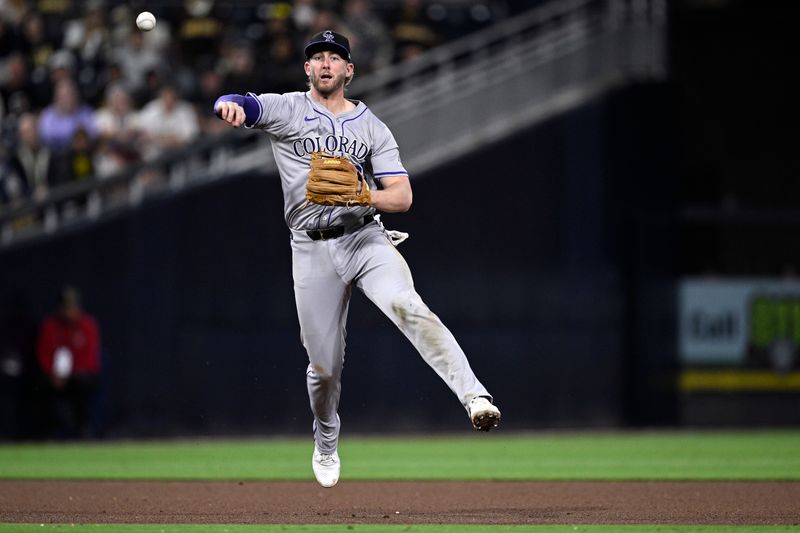 May 13, 2024; San Diego, California, USA; Colorado Rockies third baseman Ryan McMahon (24) throws to first base on a ground out by San Diego Padres right fielder Fernando Tatis Jr. (not pictured) during the seventh inning at Petco Park. Mandatory Credit: Orlando Ramirez-USA TODAY Sports