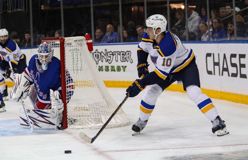 Nov 25, 2024; New York, New York, USA; St. Louis Blues center Brayden Schenn (10) plays the puck behind New York Rangers goalie Igor Shesterkin (31) during the first period at Madison Square Garden. Mandatory Credit: Danny Wild-Imagn Images