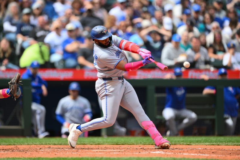May 11, 2025; Seattle, Washington, USA; Toronto Blue Jays first baseman Vladimir Guerrero Jr. (27) hits a single against the Seattle Mariners during the fifth inning at T-Mobile Park. Mandatory Credit: Steven Bisig-Imagn Images