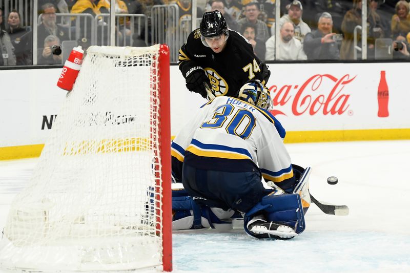 Mar 11, 2024; Boston, Massachusetts, USA;  St. Louis Blues goaltender Joel Hofer (30) makes a save on Boston Bruins left wing Jake DeBrusk (74) during the third period at TD Garden. Mandatory Credit: Bob DeChiara-USA TODAY Sports