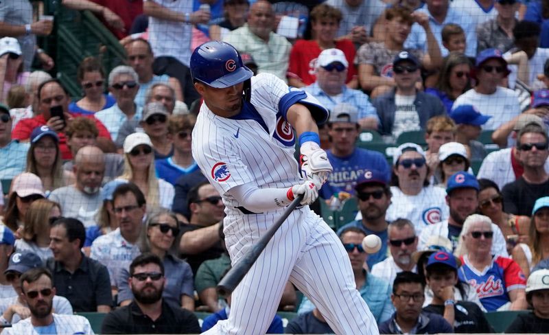 Jul 24, 2024; Chicago, Illinois, USA; Chicago Cubs outfielder Seiya Suzuki (27) hits a home run against the Milwaukee Brewers during the third inning at Wrigley Field. Mandatory Credit: David Banks-USA TODAY Sports