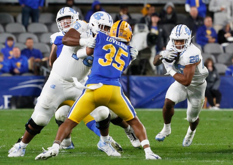 Sep 23, 2023; Pittsburgh, Pennsylvania, USA; North Carolina Tar Heels running back Omarion Hampton (28) runs with the ball against the Pittsburgh Panthers during the first quarter at Acrisure Stadium. Mandatory Credit: Charles LeClaire-USA TODAY Sports