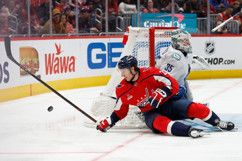 Feb 11, 2024; Washington, District of Columbia, USA; Washington Capitals center Michael Sgarbossa (23) collides with Vancouver Canucks goaltender Thatcher Demko (35) while chasing the puck in the third period at Capital One Arena. Mandatory Credit: Geoff Burke-USA TODAY Sports