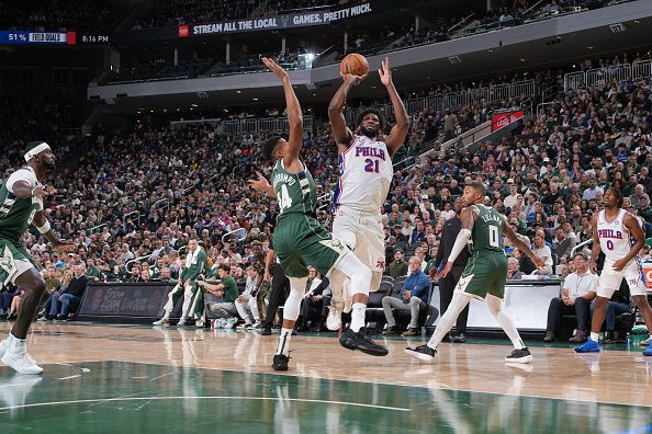 MILWAUKEE, WI - OCTOBER 26: Joel Embiid #21 of the Philadelphia 76ers shoots the ball during the game against the Milwaukee Bucks on October 26, 2023 at the Fiserv Forum Center in Milwaukee, Wisconsin. NOTE TO USER: User expressly acknowledges and agrees that, by downloading and or using this Photograph, user is consenting to the terms and conditions of the Getty Images License Agreement. Mandatory Copyright Notice: Copyright 2023 NBAE (Photo by Jesse D. Garrabrant/NBAE via Getty Images).