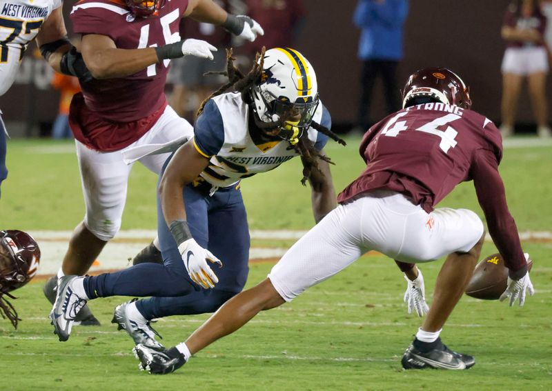 Sep 22, 2022; Blacksburg, Virginia, USA; Virginia Tech Hokies defensive back Dorian Strong (44) recovers a fumble by West Virginia Mountaineers running back Tony Mathis Jr. (24) during the second quarter at Lane Stadium. Mandatory Credit: Reinhold Matay-USA TODAY Sports