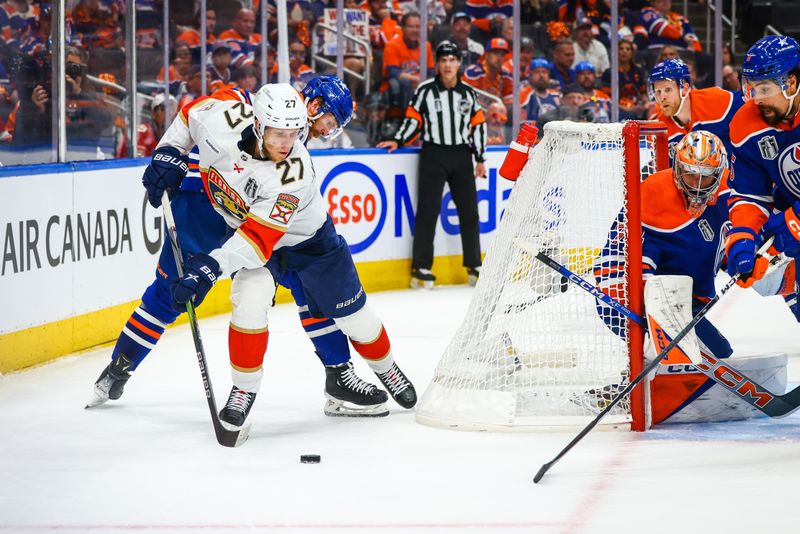 Jun 21, 2024; Edmonton, Alberta, CAN; Florida Panthers center Eetu Luostarinen (27) controls the puck behind Edmonton Oilers goaltender Stuart Skinner (74) net during the first period in game six of the 2024 Stanley Cup Final at Rogers Place. Mandatory Credit: Sergei Belski-USA TODAY Sports