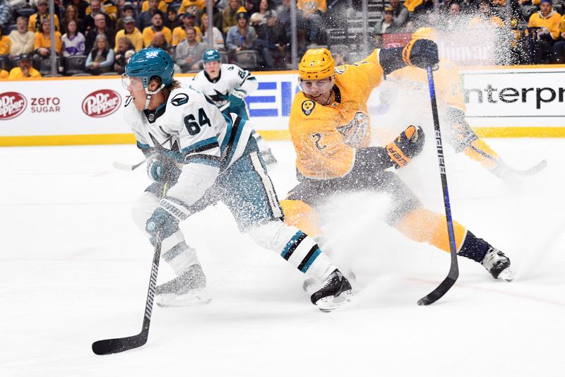 Mar 19, 2024; Nashville, Tennessee, USA; San Jose Sharks center Mikael Granlund (64) stops to pass the puck as he is defended by Nashville Predators defenseman Luke Schenn (2) during the second period at Bridgestone Arena. Mandatory Credit: Christopher Hanewinckel-USA TODAY Sports