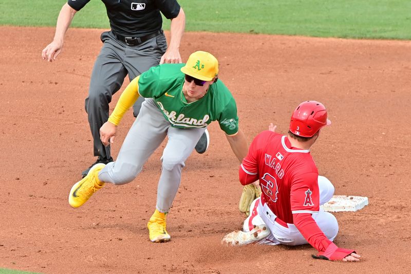 Mar 6, 2024; Tempe, Arizona, USA;  Los Angeles Angels left fielder Taylor Ward (3) steals second base on Oakland Athletics second baseman Zack Gelof (20) inthe second inning during a spring training game at Tempe Diablo Stadium. Mandatory Credit: Matt Kartozian-USA TODAY Sports