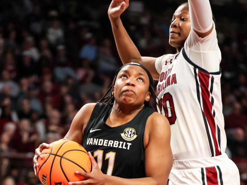 Jan 28, 2024; Columbia, South Carolina, USA; Vanderbilt Commodores guard Jordyn Oliver (11) drives around South Carolina Gamecocks forward Sania Feagin (20) in the second half at Colonial Life Arena. Mandatory Credit: Jeff Blake-USA TODAY Sports