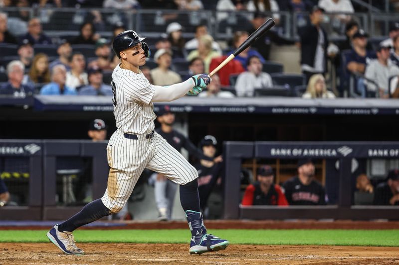 Aug 21, 2024; Bronx, New York, USA;  New York Yankees center fielder Aaron Judge (99) hits a solo home run in the seventh inning against the Cleveland Guardians at Yankee Stadium. Mandatory Credit: Wendell Cruz-USA TODAY Sports