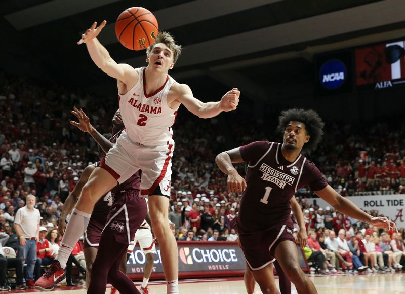 Feb 3, 2024; Tuscaloosa, Alabama, USA; Alabama forward Grant Nelson (2) reaches out for a rebound as Mississippi State forward Tolu Smith III (1) closes on the play at Coleman Coliseum. Mandatory Credit: Gary Cosby Jr.-USA TODAY Sports