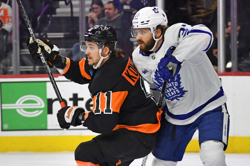 Mar 19, 2024; Philadelphia, Pennsylvania, USA; Philadelphia Flyers right wing Travis Konecny (11) and Toronto Maple Leafs defenseman Timothy Liljegren (37) battle for position during the first period at Wells Fargo Center. Mandatory Credit: Eric Hartline-USA TODAY Sports