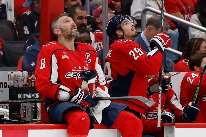 Apr 26, 2024; Washington, District of Columbia, USA; Washington Capitals left wing Alex Ovechkin (8) and Capitals center Hendrix Lapierre (29) look up at the scoreboard during a timeout against the New York Rangers in the third period in game three of the first round of the 2024 Stanley Cup Playoffs at Capital One Arena. Mandatory Credit: Geoff Burke-USA TODAY Sports