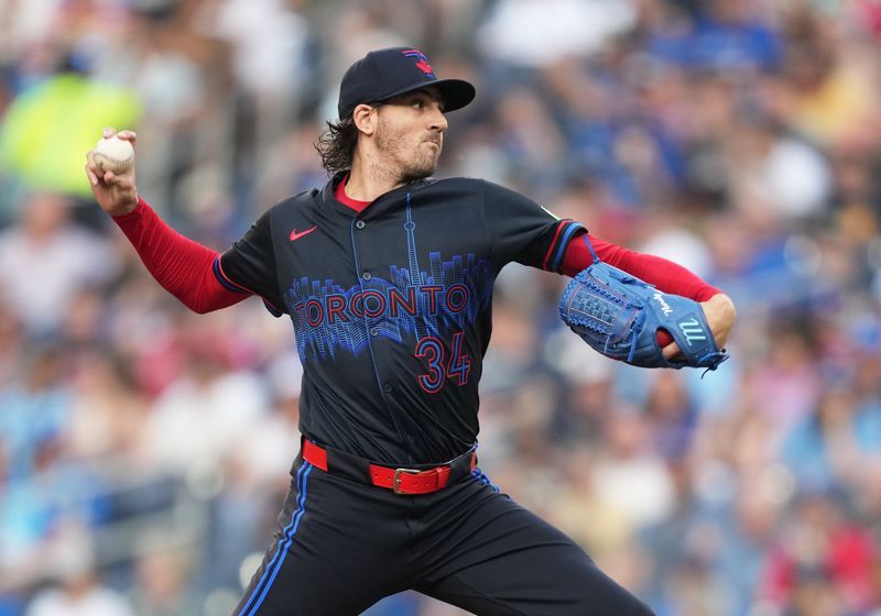 Jun 19, 2024; Toronto, Ontario, CAN; Toronto Blue Jays starting pitcher Kevin Gausman (34) throws a pitch against the Boston Red Sox during the first inning at Rogers Centre. Mandatory Credit: Nick Turchiaro-USA TODAY Sports