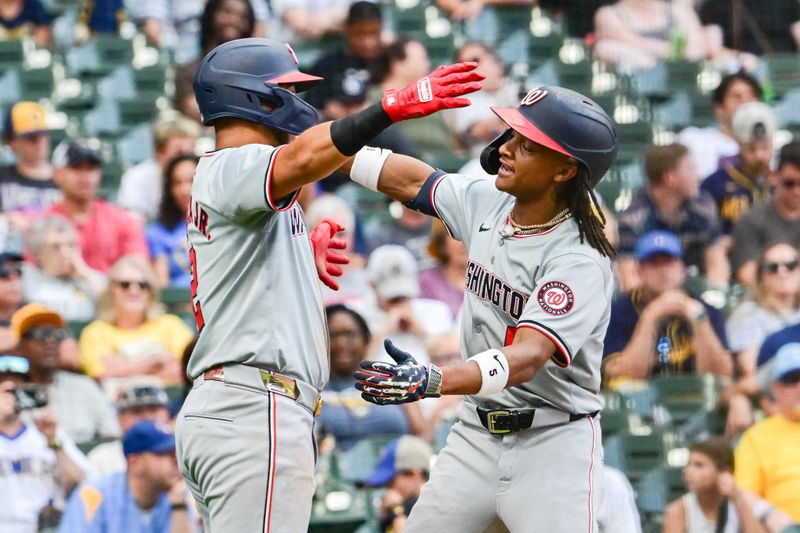 Jul 13, 2024; Milwaukee, Wisconsin, USA; Washington Nationals shortstop C.J. Abrams (5) hugs second baseman Luis Garcia (2) after hitting a 2-run home run against the Milwaukee Brewers in the ninth inning at American Family Field. Mandatory Credit: Benny Sieu-USA TODAY Sports