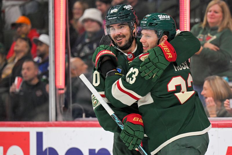 Nov 1, 2025; Saint Paul, Minnesota, USA;  Minnesota Wild forward Marco Rossi (23) celebrates his goal against the Vancouver Canucks with forward Marcus Johansson (90) during the second period at Grand Casino Arena. Mandatory Credit: Nick Wosika-Imagn Images