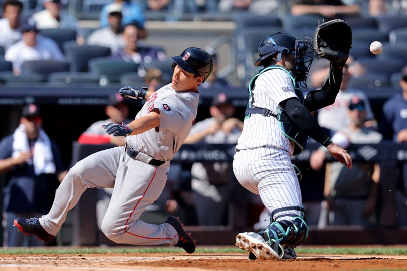 Sep 14, 2024; Bronx, New York, USA; Boston Red Sox designated hitter Masataka Yoshida (7) scores a run against New York Yankees catcher Austin Wells (28) on an RBI single by Red Sox right fielder Wilyer Abreu (not pictured) during the fourth inning at Yankee Stadium. Mandatory Credit: Brad Penner-Imagn Images