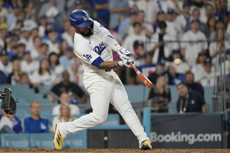 Oct 11, 2024; Los Angeles, California, USA; Los Angeles Dodgers outfielder Teoscar Hernandez (37) hits a solo home run in the seventh inning against the San Diego Padres during game five of the NLDS for the 2024 MLB Playoffs at Dodger Stadium. Mandatory Credit: Jayne Kamin-Oncea-Imagn Images
