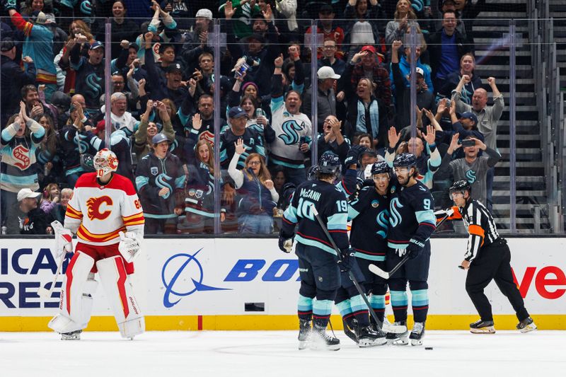 Oct 19, 2024; Seattle, Washington, USA; Seattle Kraken center Chandler Stephenson (9) celebrates with teammates after scoring a goal against the Calgary Flames during the second period at Climate Pledge Arena. Mandatory Credit: Caean Couto-Imagn Images