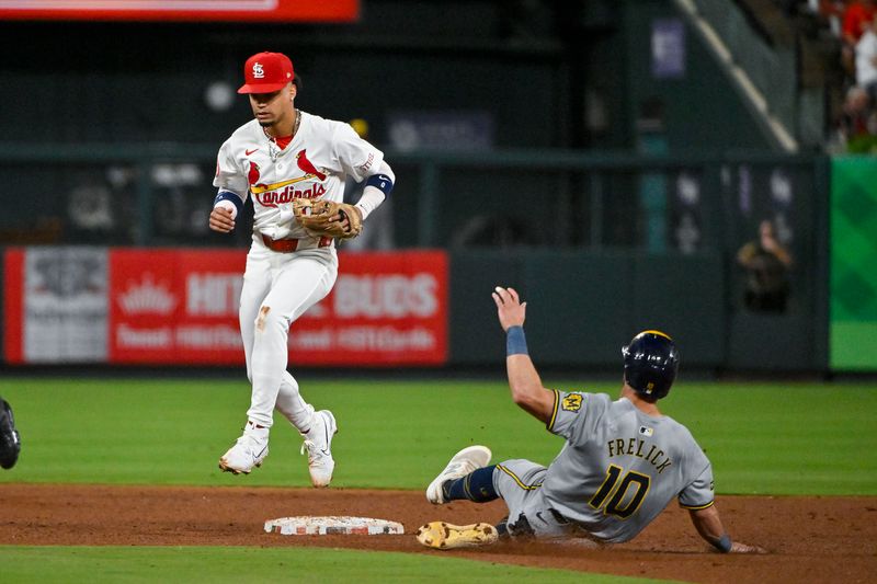 Aug 21, 2024; St. Louis, Missouri, USA;  St. Louis Cardinals shortstop Masyn Winn (0) leaps past second base after forcing out Milwaukee Brewers right fielder Sal Frelick (10) during the fifth inning at Busch Stadium. Mandatory Credit: Jeff Curry-USA TODAY Sports