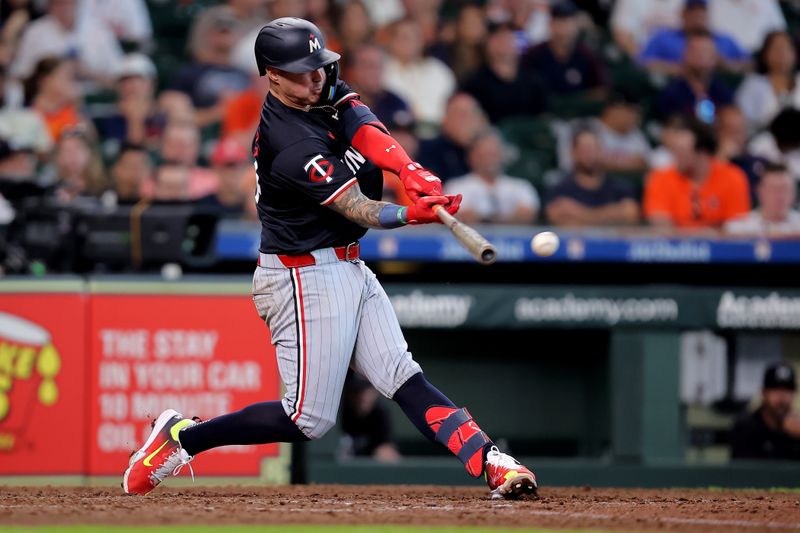 Jun 2, 2024; Houston, Texas, USA; Minnesota Twins third baseman Jose Miranda (64) hits an RBI double against the Houston Astros during the eighth inning at Minute Maid Park. Mandatory Credit: Erik Williams-USA TODAY Sports