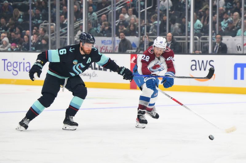 Nov 13, 2023; Seattle, Washington, USA; Seattle Kraken defenseman Adam Larsson (6) and Colorado Avalanche left wing Miles Wood (28) chase the puck during the first period at Climate Pledge Arena. Mandatory Credit: Steven Bisig-USA TODAY Sports