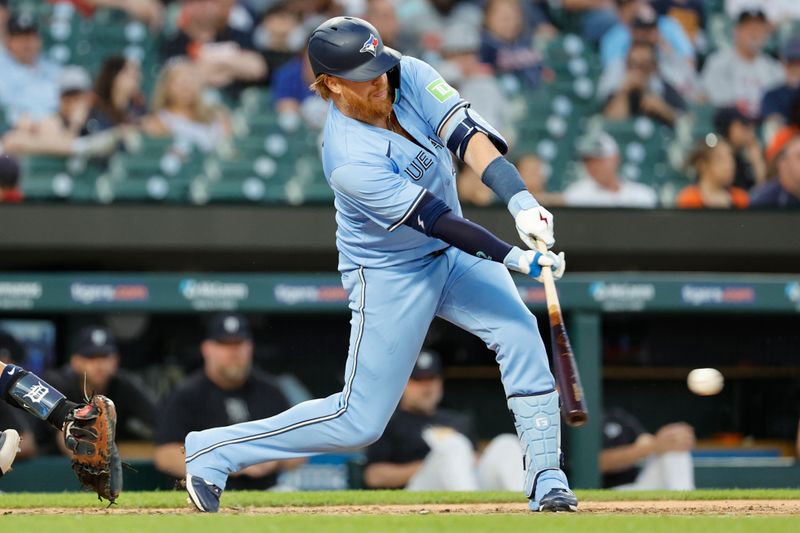 May 23, 2024; Detroit, Michigan, USA;  Toronto Blue Jays third baseman Justin Turner (2) hits a RBI single in the eighth inning against the Detroit Tigers at Comerica Park. Mandatory Credit: Rick Osentoski-USA TODAY Sports