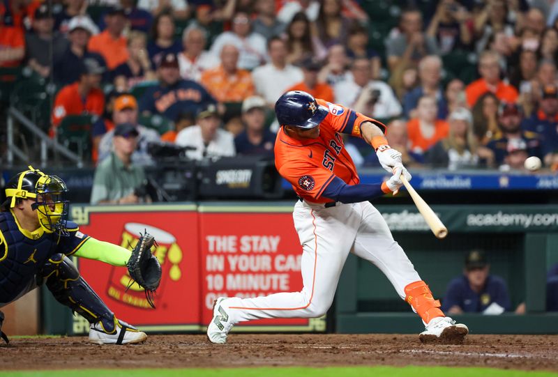 May 17, 2024; Houston, Texas, USA;  Houston Astros shortstop Jeremy Pena (3) hits a three-run home run against the Milwaukee Brewers in the fifth inning at Minute Maid Park. Mandatory Credit: Thomas Shea-USA TODAY Sports