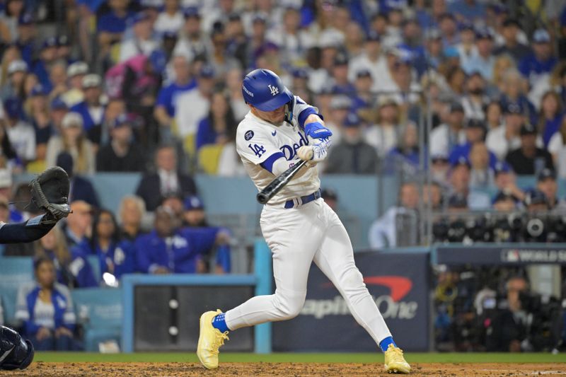 Oct 25, 2024; Los Angeles, California, USA; Los Angeles Dodgers third baseman Enrique Hernandez (8) hits triple in the fifth inning against the New York Yankees during game one of the 2024 MLB World Series at Dodger Stadium. Mandatory Credit:  Jayne Kamin-Oncea-Imagn Images