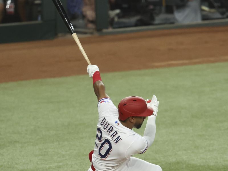 Jun 28, 2023; Arlington, Texas, USA;  Texas Rangers left fielder Ezequiel Duran (20) hits an rbi single during the first inning against the Detroit Tigers at Globe Life Field. Mandatory Credit: Kevin Jairaj-USA TODAY Sports