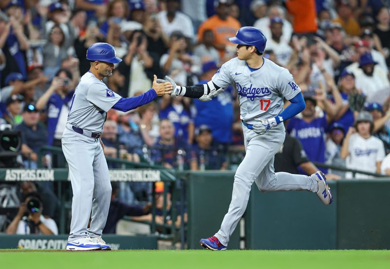 Jul 27, 2024; Houston, Texas, USA; Los Angeles Dodgers designated hitter Shohei Ohtani (17) celebrates with third base coach Dino Ebel (91) after hitting a home run during the third inning against the Houston Astros at Minute Maid Park. Mandatory Credit: Troy Taormina-USA TODAY Sports