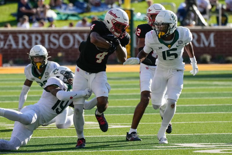 Nov 4, 2023; Waco, Texas, USA;  Houston Cougars wide receiver Samuel Brown (4) makes a catch and is tackled by Baylor Bears cornerback Caden Jenkins (19) during the second half at McLane Stadium. Mandatory Credit: Chris Jones-USA TODAY Sports