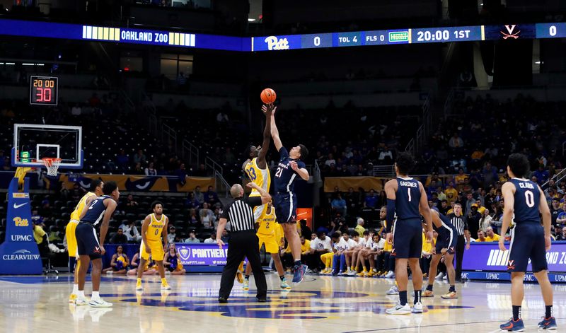 Jan 3, 2023; Pittsburgh, Pennsylvania, USA; Pittsburgh Panthers center Federiko Federiko (33) and Virginia Cavaliers forward Kadin Shedrick (21) take the opening tip-off at the Petersen Events Center. Mandatory Credit: Charles LeClaire-USA TODAY Sports