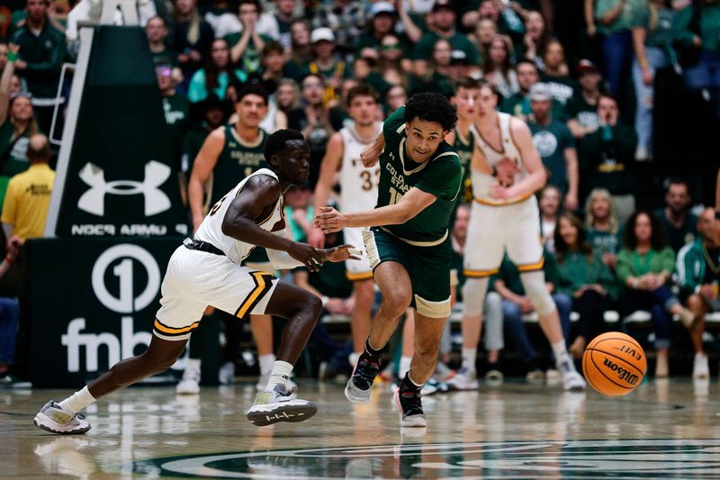 Mar 2, 2024; Fort Collins, Colorado, USA; Colorado State Rams guard Jalen Lake (15) rushes for a loose ball ahead of Wyoming Cowboys guard Akuel Kot (13) in the first half at Moby Arena. Mandatory Credit: Isaiah J. Downing-USA TODAY Sports